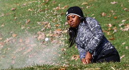 An African-American female golfer blasts out of the bunker during the 2016 State Tournament.