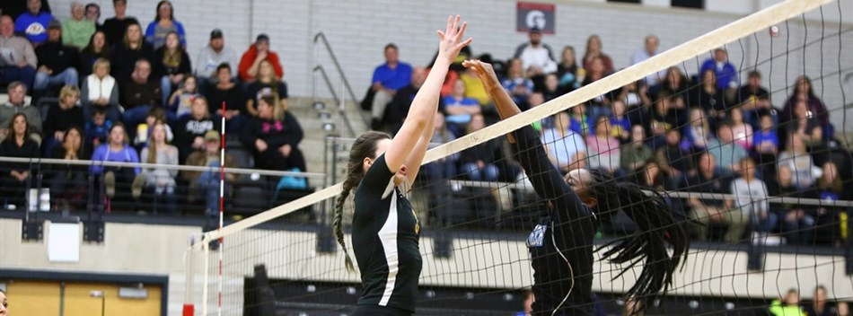 A Western Tech and Clear Spring player play above the net in the 2018 Class 1A State Volleyball Fina