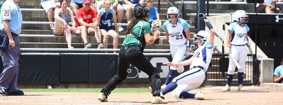 A baserunner slides home safely ahead of the throw in the 2019 Class 2A State Softball Final.