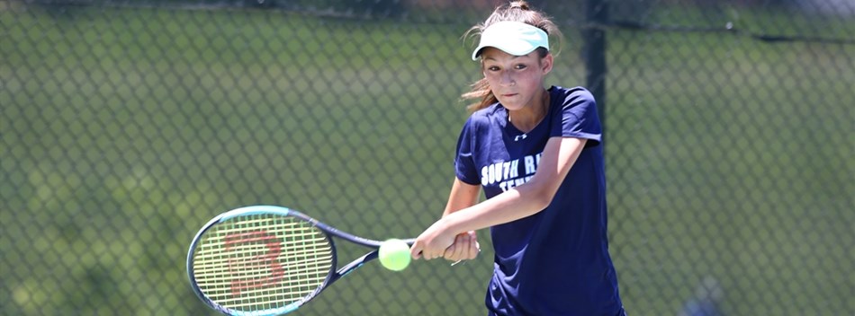 A female player hits a two-handed forehand shot during the 2019 State Tennis Tournament.