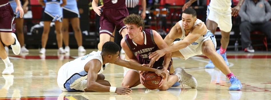 Male players scramble for a loose ball on the floor during the 2019 Class 4A State Semifinals.