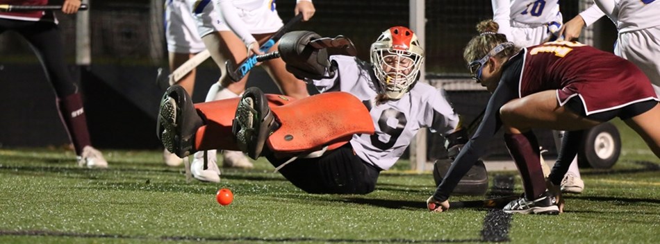 An attacker plays a rebound off of the goalie's pads in the 2018 Class 2A State Field Hockey Final.