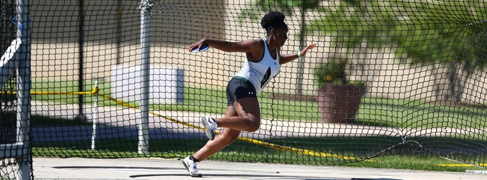 A female discus thrower spins during an attempt at the 2019 State Track and Field Meets.
