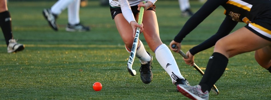 A Patuxent player dodges a South Carroll player in the 2018 Class 1A State Field Hockey Final.