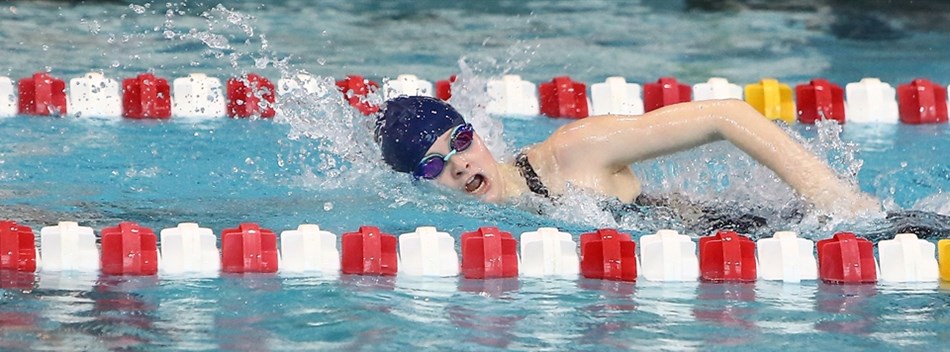 A female competes in a freestyle race at the 2019 Class 4A/3A State Meet.