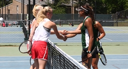 Two Girls Doubles team shake ends at the net after a match in the 2018 State Tournament.