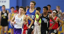 Male distance runners head into the turn at the PG Sportsplex at the 2018 State Championships.