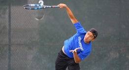A male singles player focuses on the point of contact during a serve at the 2017 State Championships.