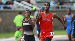 Two male runners sprint towards the finish line in the 2017 State Championship meets at Morgan State University.