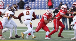 A Fort Hill football player follows his blockers through the Dunbar defense during the 2017 Class 1A State Finals.