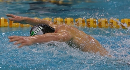 A male swimmer competes in a butterfly race at the 2017 State Championships.