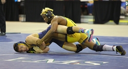 A male Perryville wrestler and male South Carroll wrestler are in a "scramble" on the mat during the 2017 State Championships.