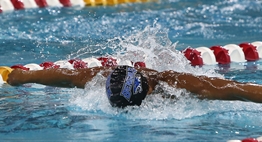 A male swimmer races in the butterfly at the 2018 State Meets.
