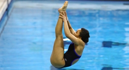 A female diver performs a reverse pike during the 2017 State Championships.