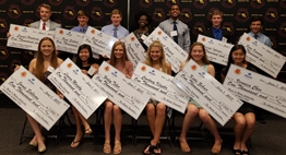 Photo of all of the 2017 Minds In Motion Scholarship winners holding their oversized checks.