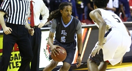 A Roosevelt player tries to dribble around a defender at the 2017 Boys State Basketball Tournament.