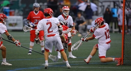 In the 2017 Class 3A/2A Boys State Lacrosse Final, a Northern-Calvert plays dives while taking a shot on the Glenelg goalie.