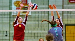 A Patuxent spiker hits the ball between two Hereford blockers at the net during the 2015 State Semifinals.