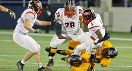 Wise defenders tackle a Quince Orchard ball carrier in the 2016 State 4A Football Final.