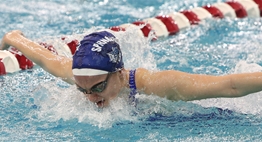 A female swimmer competes in the butterfly at the 2018 State Championship Meets.