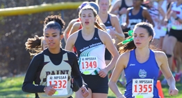Female runners in the Class 4A race head into a turn during the 2016 State Championships.