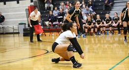 A libero prepares to dig the ball at the 2018 State Volleyball Tournament.