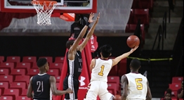 A male player drives the lane and tries to avoid the defender's block in a 2018 State Final game.