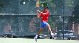 A male singles player hits a two-handed backhand return in the 2018 State Tennis Tournament.
