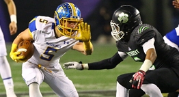 A Walkersville ballrunner stiff arms a Patuxent defender in 2015 State Finals.