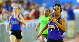 Female runners sprint towards the finish line at the 2017 State Indoor Track Finals.