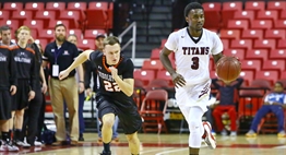 A male basketball player from Middletown hustles back on defense against a New Town ball handler in 2016 State Finals action.