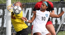 A goalie makes an upright save at the post with an attacker right next to her during the 2017 State Class 3A Girls Soccer Finals.