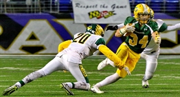 A Damascus running back tries to elude the tackle of a Dundalk defender in the 2015 Class 3A State Final.