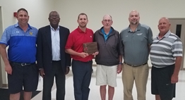 Executive Director Andy Warner presents award to Clarence Johnson surrounded by friends and co-workers at the District 8 Dinner Meeting on 5/10/18.