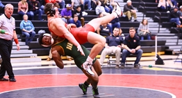 A wrestler prepares to take down an opponent from a standing position at the 2017 State Duals Tournament.