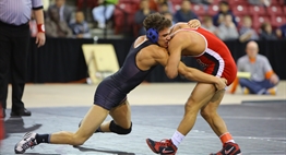 Two male wrestlers grapple while trying to execute a takedown on one another at the 2017 State Championships.