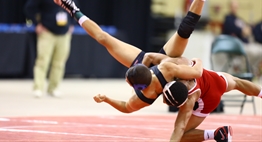 One wrestler executes a takedown on another wrestler in the 2016 State Tournament.