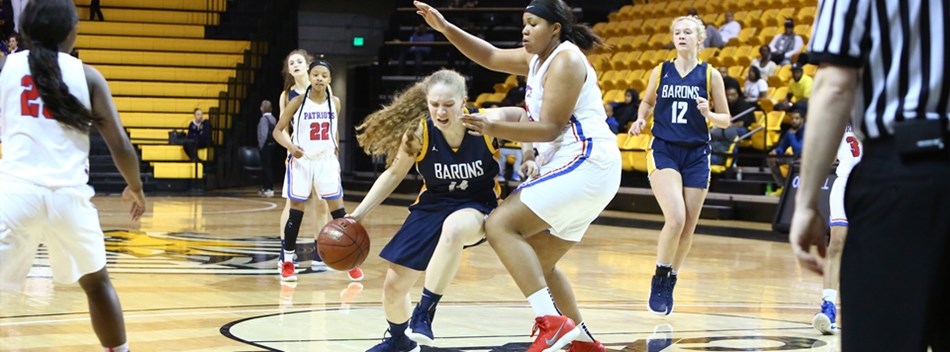 A female guard drives to the basket against a much taller opponent in the 2019 Class 4A State Basket
