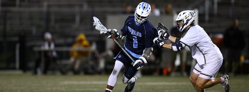 A male player cradles the ball in his stick while closely guarded at the 2019 State 4A Final.