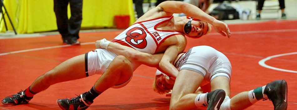 A male wrestler spins out of a hold by his opponent during the 2019 Class 4A/3A State Tournament.