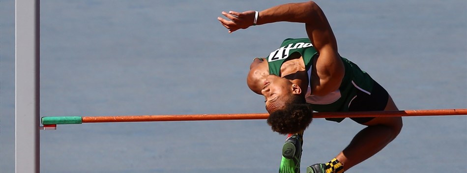 A male high jumper crosses above the bar during an attempt at the 2019 State Track and Field Meets.