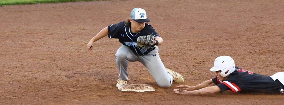 A fielder prepares to slap a tag on a sliding runner at the 2019 Class 3A State Baseball Final.