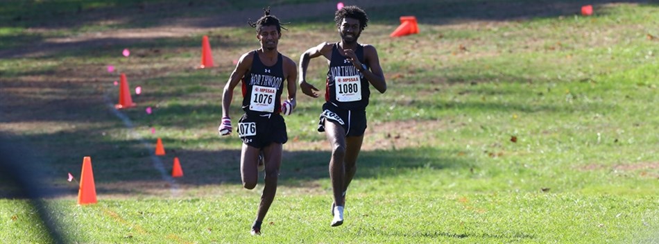 Two male runners lead the pack during the 2018 Class 4A State Cross Country Championships.