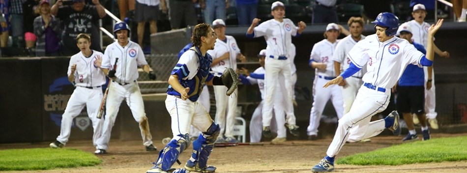 A runner prepares to slide home ahead of the throw at the 2019 Class 4A State Baseball Final.